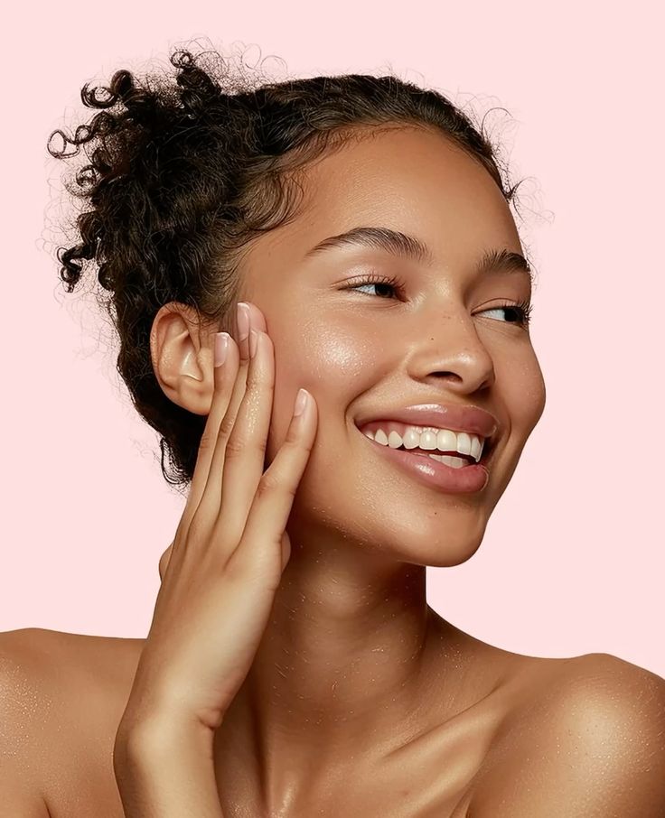 A smiling woman enjoying a skincare ritual